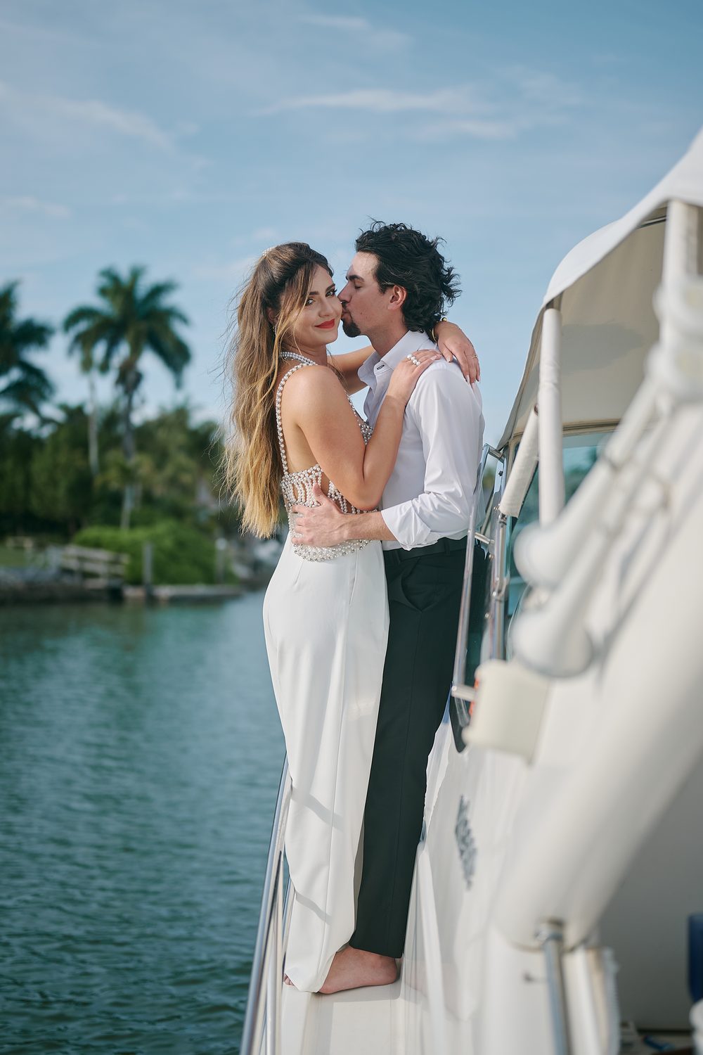 An embrace beneath the palms, a breath from a kiss