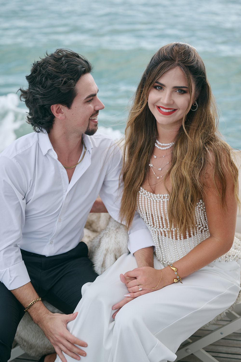 Seated close on deck, his eyes on her