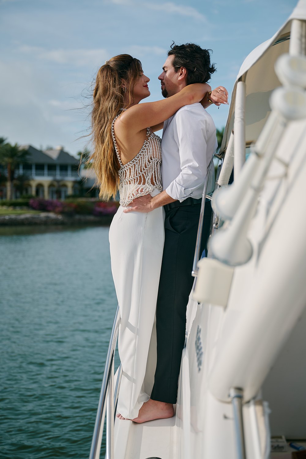 Her arms around his neck at the rail