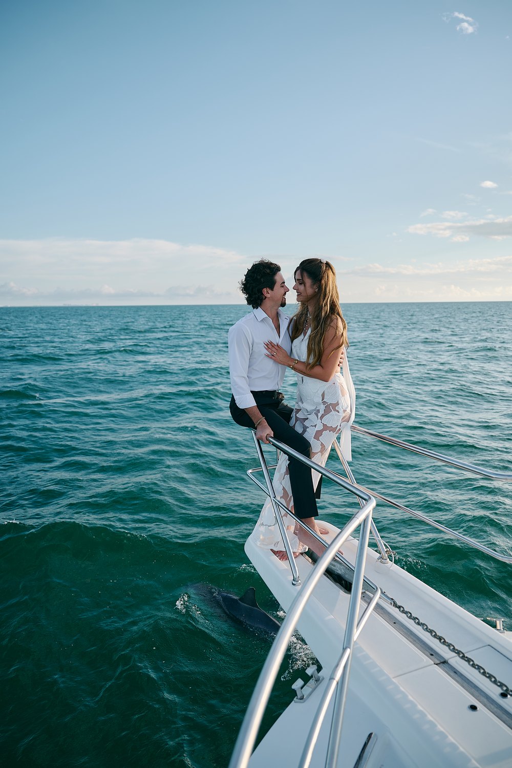 Together on the bow over open turquoise