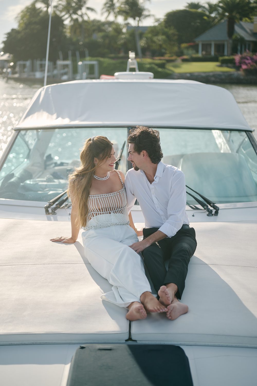 Seated on the bow in golden light, the resort behind