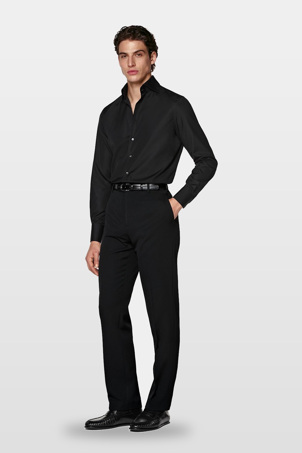 A black shirt with tailored trousers