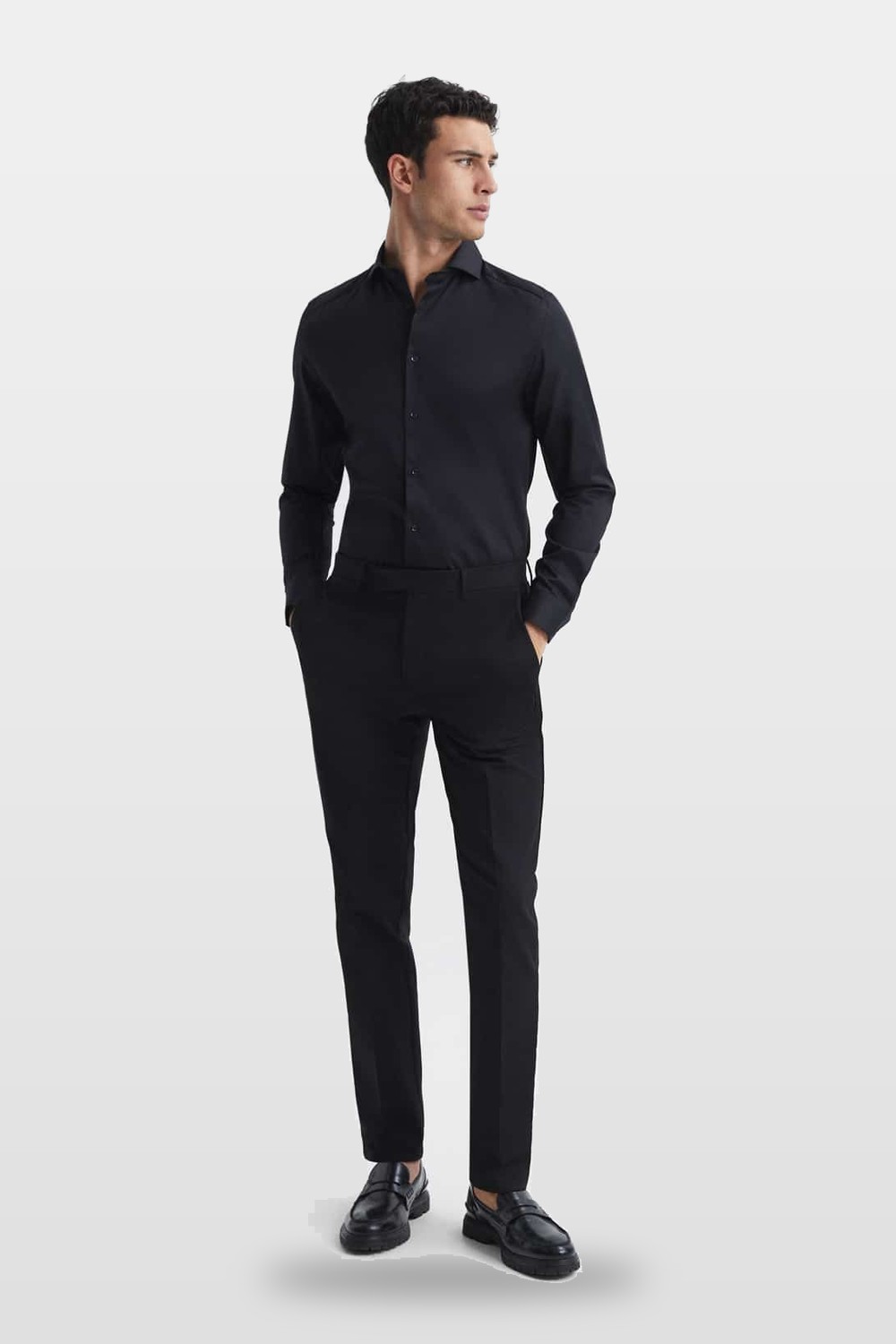 A slim black shirt and trousers